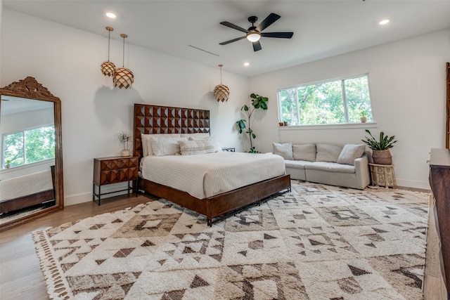 bedroom featuring light hardwood / wood-style flooring and ceiling fan