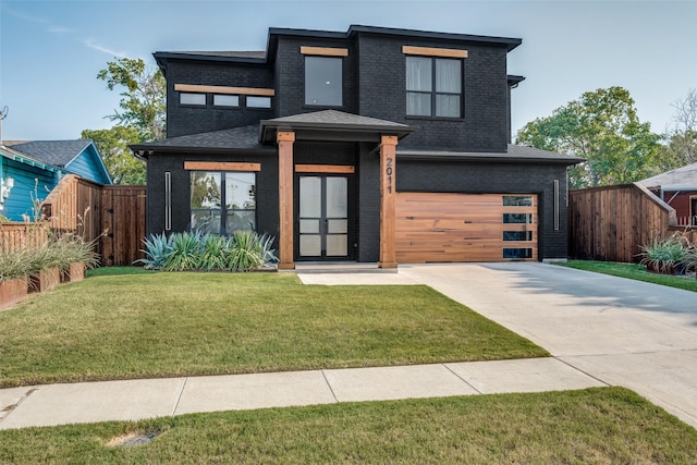 view of front of property featuring a garage and a front lawn