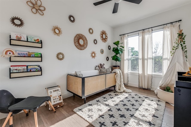 bedroom with hardwood / wood-style flooring and ceiling fan