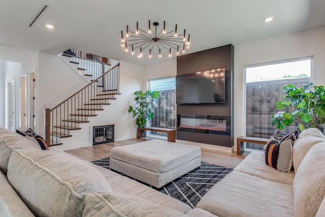 living room featuring a large fireplace and light hardwood / wood-style floors