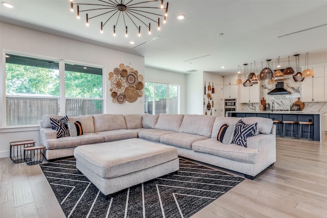 living room with light hardwood / wood-style flooring and sink