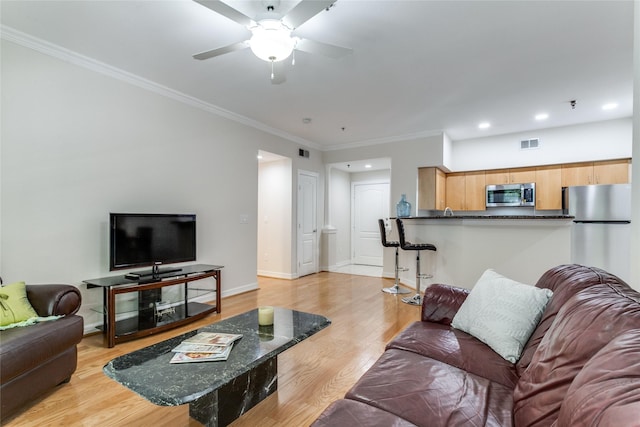 living room with ceiling fan, light hardwood / wood-style flooring, and ornamental molding