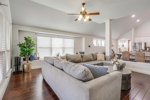 living room with ceiling fan, lofted ceiling, dark wood-type flooring, and decorative columns