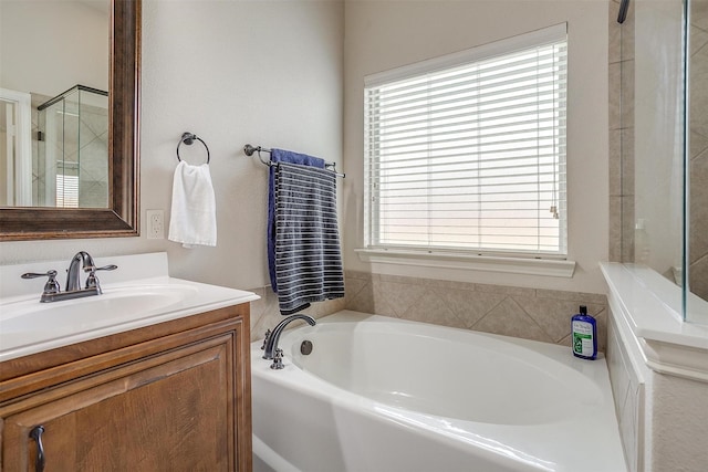 bathroom featuring vanity and independent shower and bath