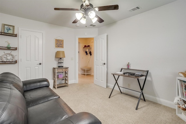 living room with ceiling fan and light carpet