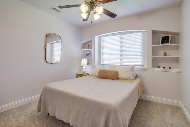 bedroom with ceiling fan and light carpet