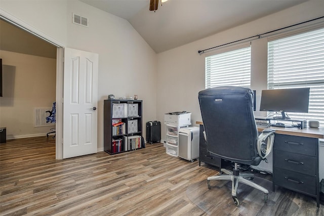 office space with ceiling fan, light hardwood / wood-style flooring, and vaulted ceiling