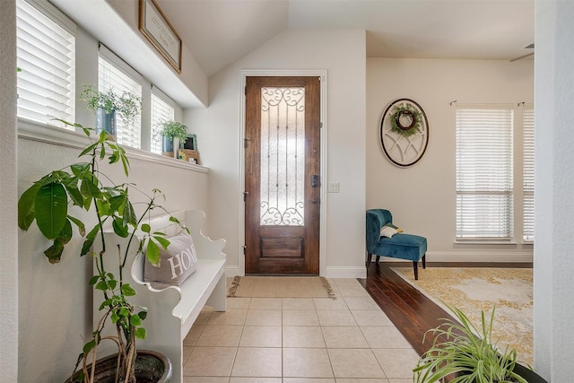 entryway featuring lofted ceiling and light tile patterned floors