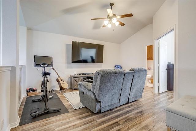 living room with ceiling fan, lofted ceiling, and light wood-type flooring