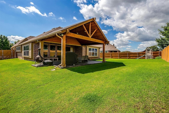 rear view of property with a patio area and a yard