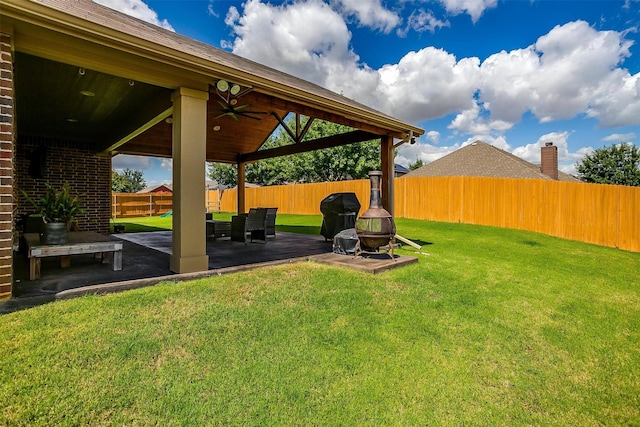 view of yard featuring ceiling fan and a patio area