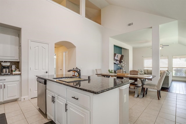 kitchen featuring white cabinetry, sink, dishwasher, a kitchen island with sink, and light tile patterned floors