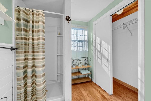 bathroom with hardwood / wood-style floors