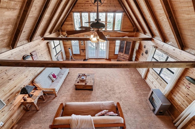 interior space featuring beamed ceiling, carpet flooring, wood walls, and wood ceiling