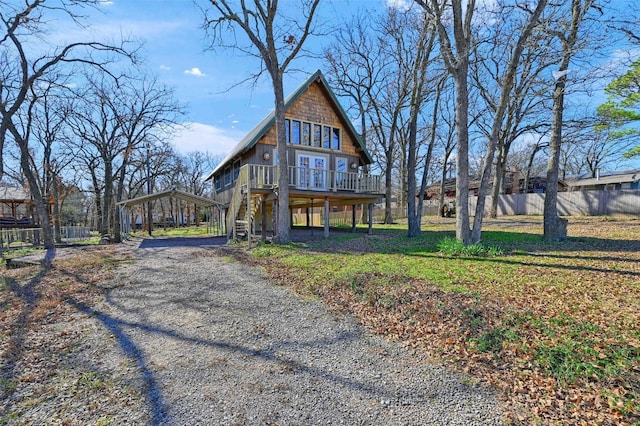 view of front of home featuring a carport and a wooden deck