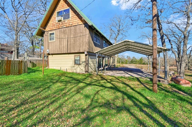 back of house with a lawn and a carport