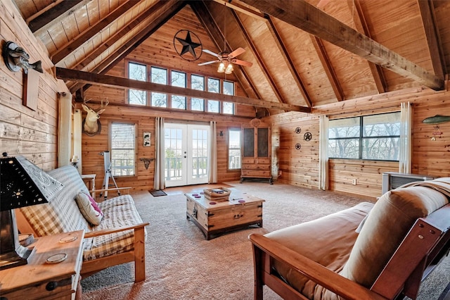 carpeted living room featuring beamed ceiling, french doors, wooden ceiling, and wooden walls