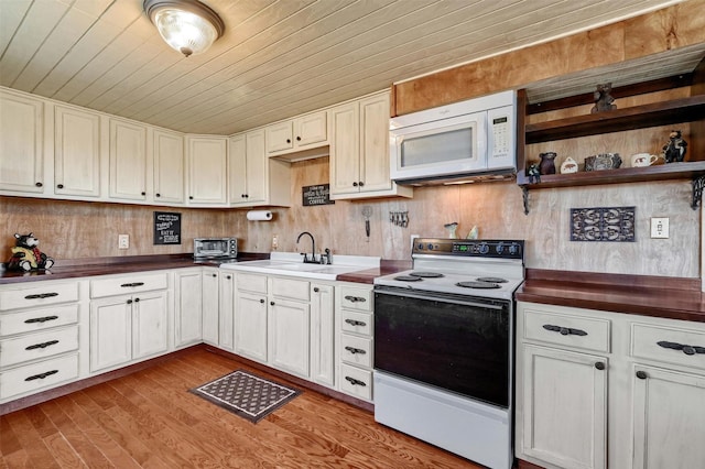 kitchen with wooden walls, light hardwood / wood-style floors, white appliances, and wood ceiling