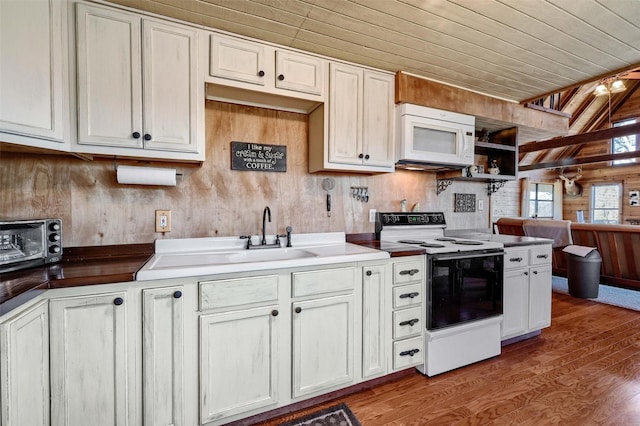 kitchen featuring wood walls, sink, wooden ceiling, and white appliances