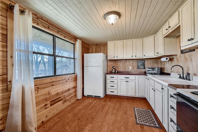 kitchen featuring wood walls, white appliances, sink, and wood ceiling