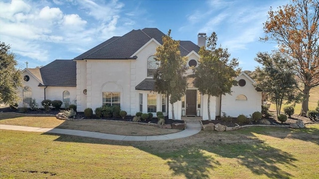 french country inspired facade featuring a front yard