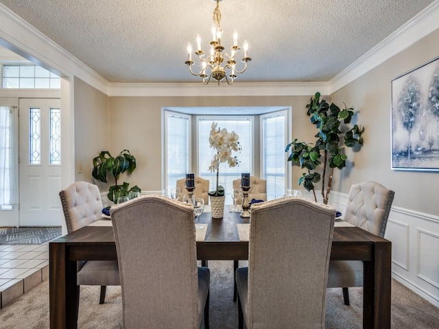 dining area with crown molding, carpet, a chandelier, and a textured ceiling