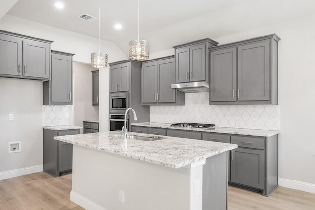 kitchen featuring stainless steel appliances, gray cabinetry, and sink