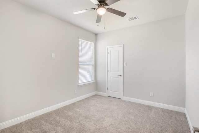 unfurnished room featuring ceiling fan and carpet floors