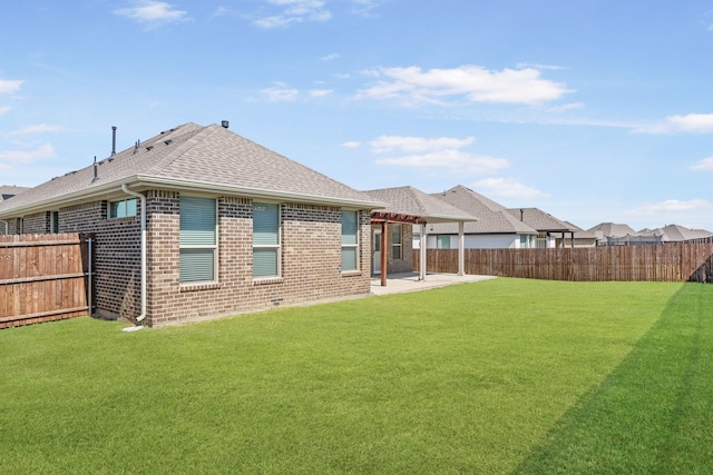 rear view of property with a lawn and a patio area