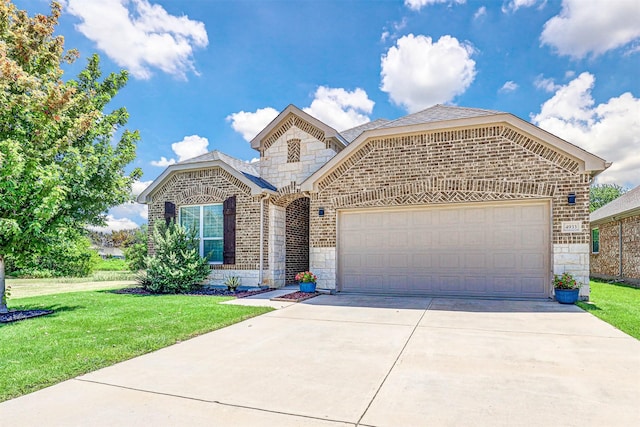 front facade featuring a garage and a front yard