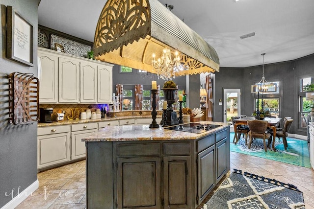 kitchen featuring black electric stovetop, plenty of natural light, light stone countertops, and backsplash