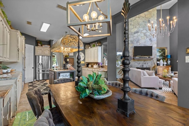 dining area with a fireplace and a chandelier