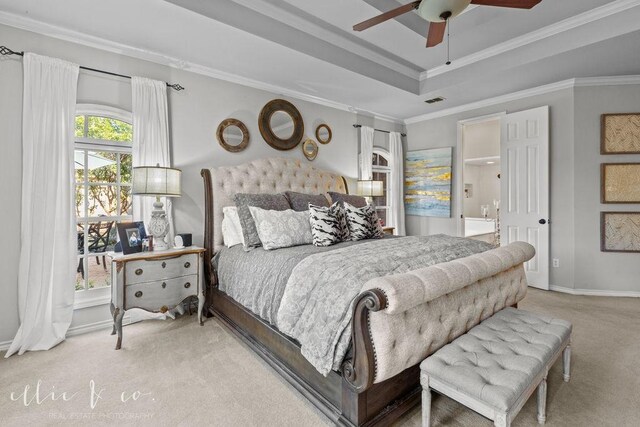 bedroom featuring a tray ceiling, ceiling fan, carpet, and ornamental molding