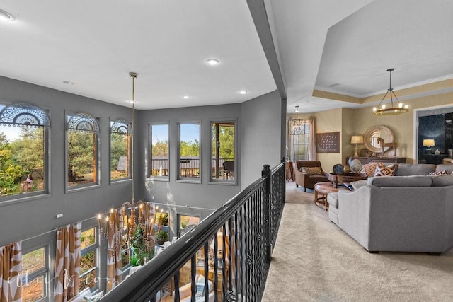 interior space with plenty of natural light, crown molding, and an inviting chandelier