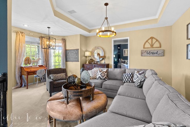 carpeted living room with a tray ceiling, crown molding, and a notable chandelier