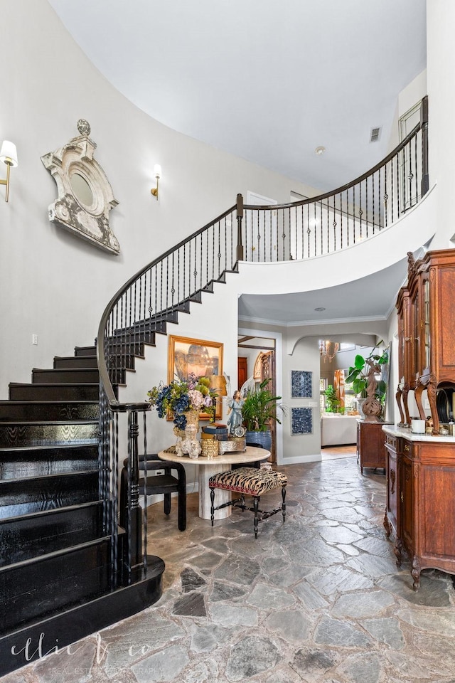 stairs featuring a high ceiling