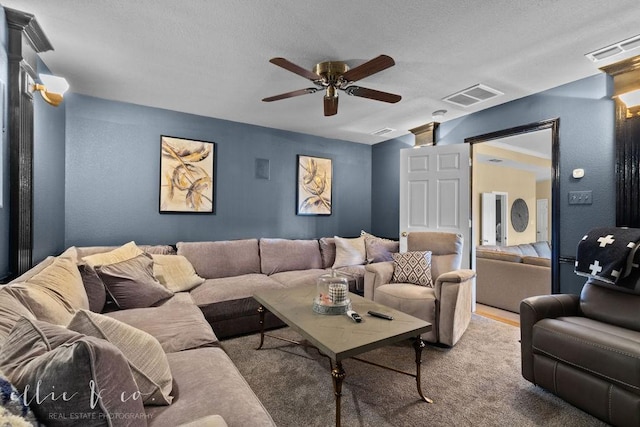 carpeted living room with ceiling fan and a textured ceiling