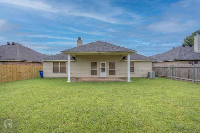 back of property featuring a lawn, cooling unit, and a patio