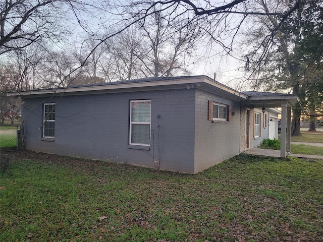 view of home's exterior with a lawn