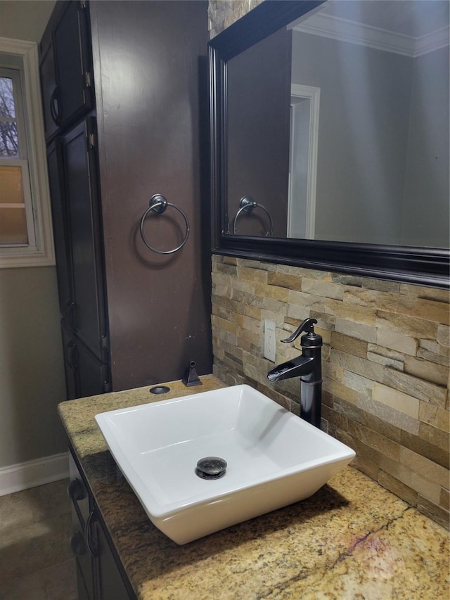 bathroom featuring decorative backsplash, vanity, and ornamental molding