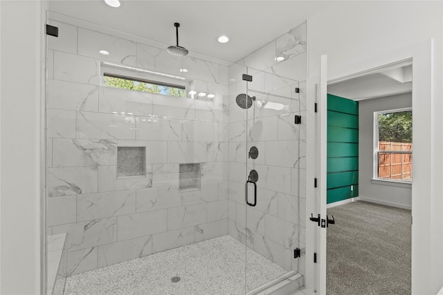 bathroom featuring a shower with door