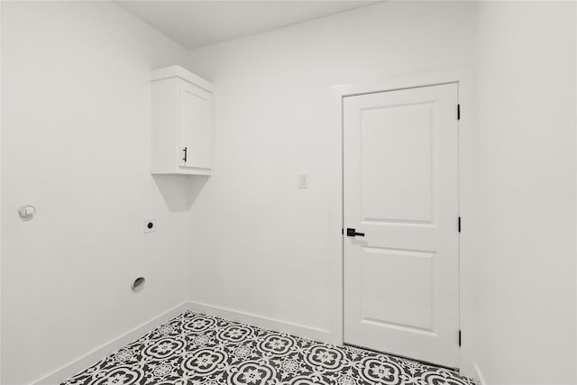 laundry area with tile patterned flooring, cabinets, and hookup for an electric dryer