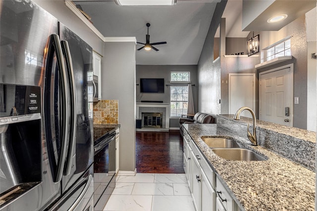 kitchen featuring sink, electric range, refrigerator with ice dispenser, light stone countertops, and white cabinets