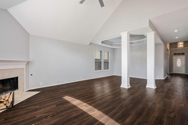 unfurnished living room with a fireplace, hardwood / wood-style floors, decorative columns, and ceiling fan