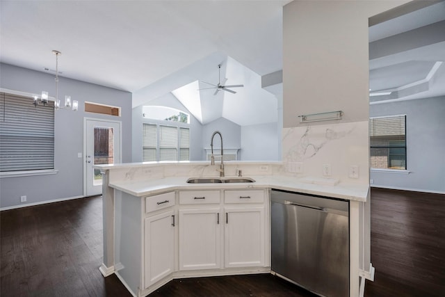 kitchen featuring sink, hanging light fixtures, stainless steel dishwasher, decorative backsplash, and white cabinets