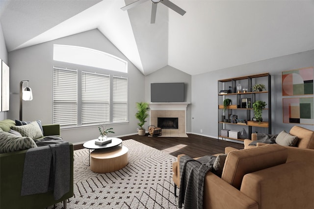 living room with hardwood / wood-style floors, ceiling fan, lofted ceiling, and a tile fireplace