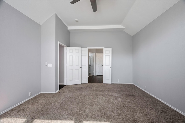 unfurnished bedroom featuring carpet flooring, vaulted ceiling, and ceiling fan