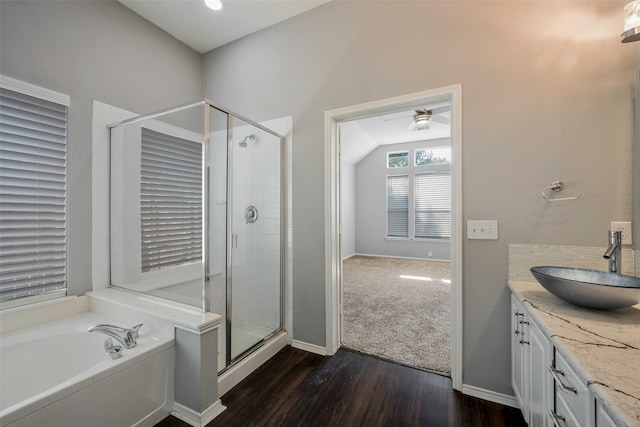 bathroom with ceiling fan, vanity, wood-type flooring, and shower with separate bathtub