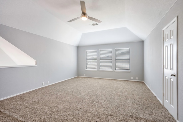 interior space featuring ceiling fan, carpet, and lofted ceiling