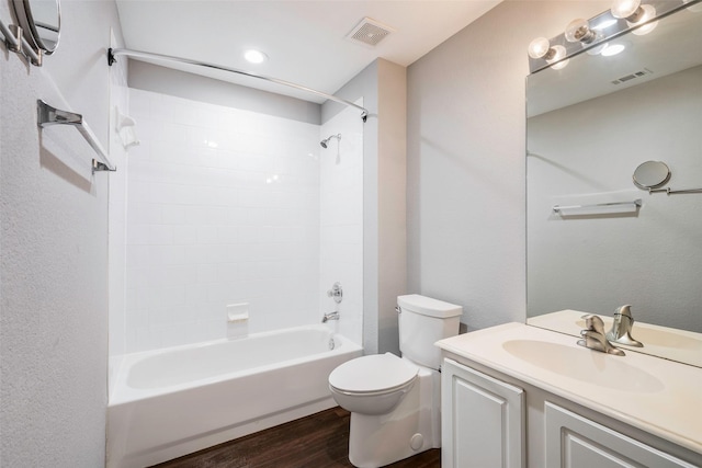 full bathroom with hardwood / wood-style floors, vanity, bathtub / shower combination, and toilet